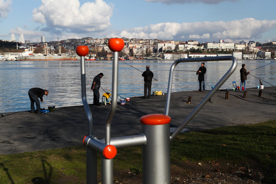 Men fish on the banks of the Golden Horn in Istanbul.