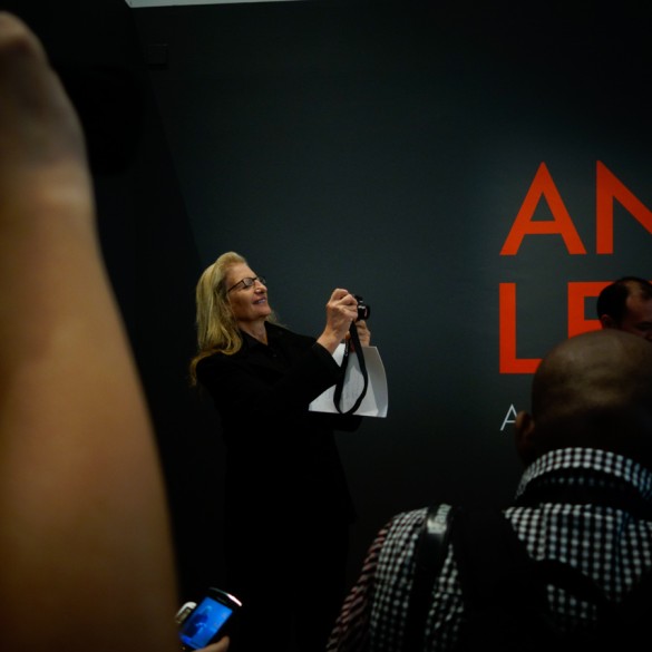 Annie takes a picture at the opening of her exhibition.