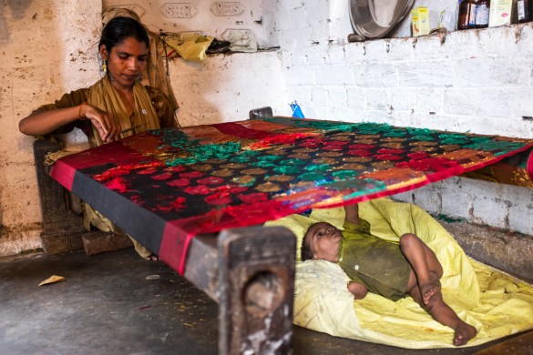 For 30 cents a day, Rukhsana spends hours on end laboring to finish an already woven saree, as her fourth child, also malnourished entertains himself.